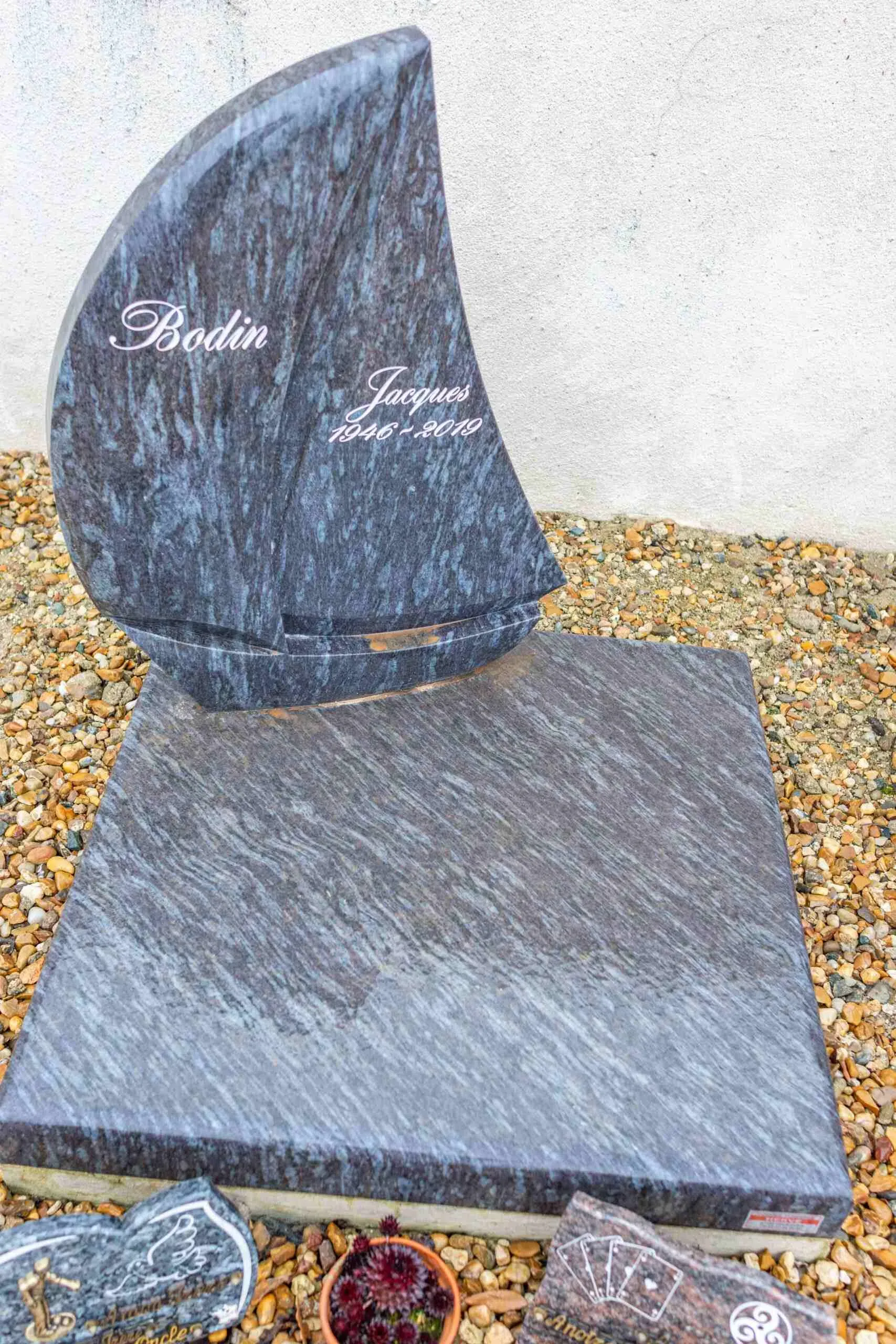 Stèle en granite bleu taillée en forme de voilier gravée au nom de Bodin Jacques.
